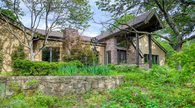 front view of a house with a tree