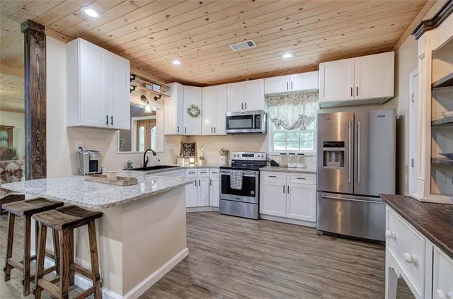 a view of a house with backyard porch and sitting area