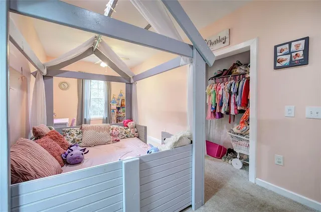 a living room with furniture a fireplace and a chandelier