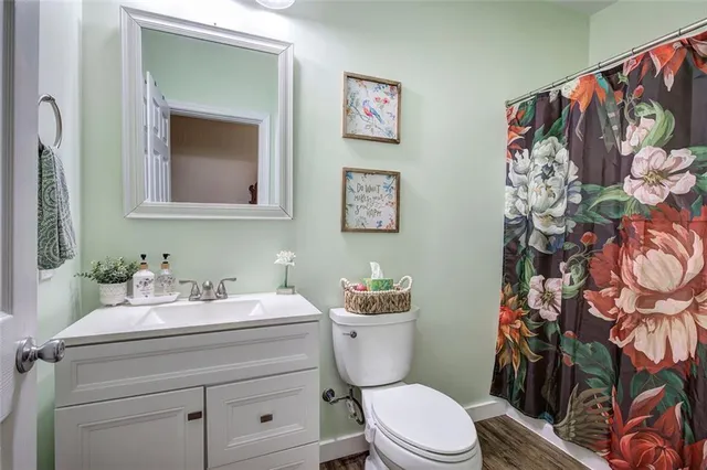 a bedroom with a bed a dresser and potted plants