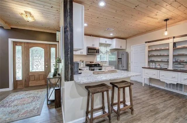 a bedroom with a bed a walk in closet and a window