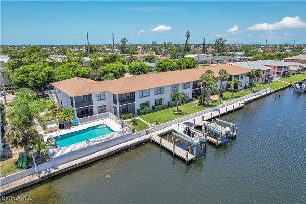 an aerial view of a house with a garden and lake view