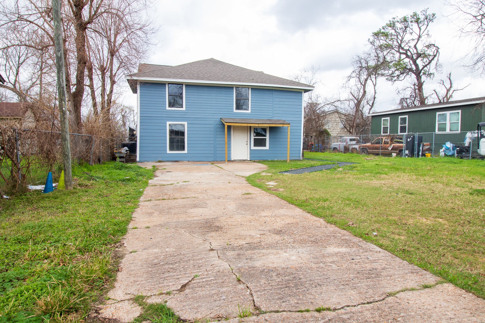 a front view of a house with a yard and trees