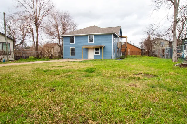a front view of house with yard and trees