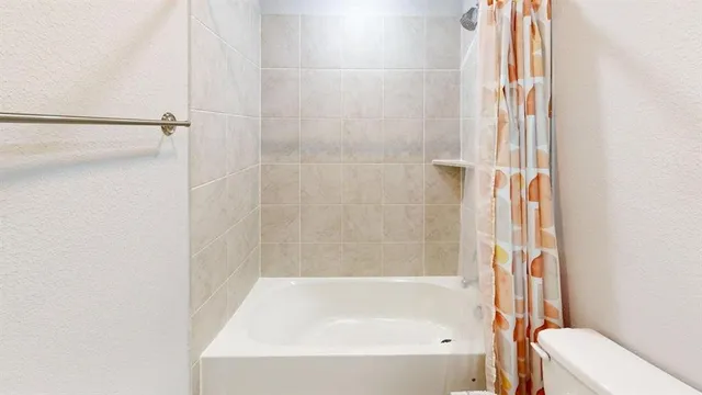 a bathroom with a toilet a sink and a shower