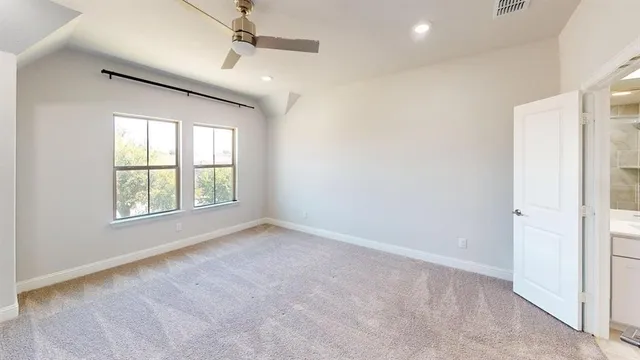 an empty room with fan and entrance