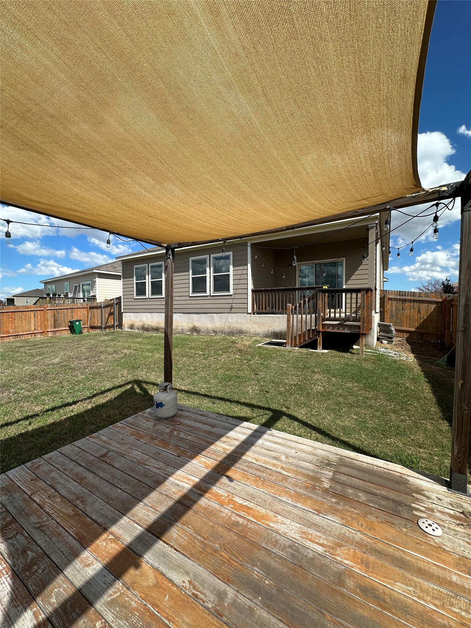 13000 Titanium Street Austin, TX 78754 - Photo 14 of 15 Expansive backyard featuring a wood deck with a fabric shade structure