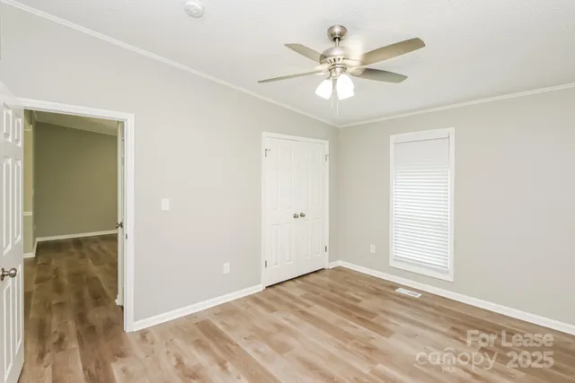 a view of a livingroom with a ceiling fan and wooden floor