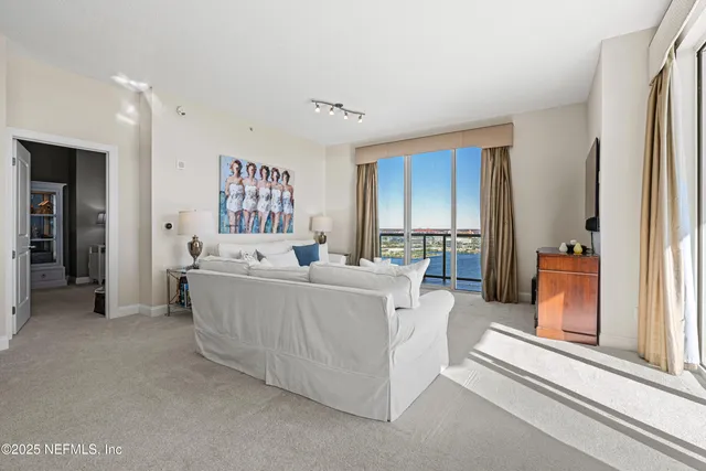 a living room with furniture and a large mirror