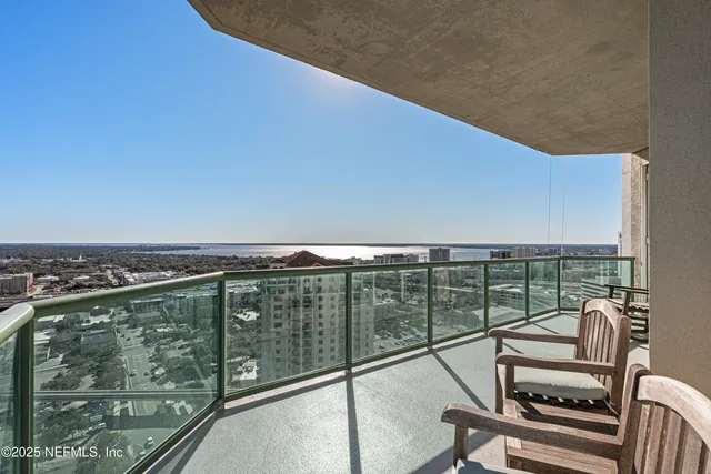 a view of a balcony with chair and floor to ceiling window