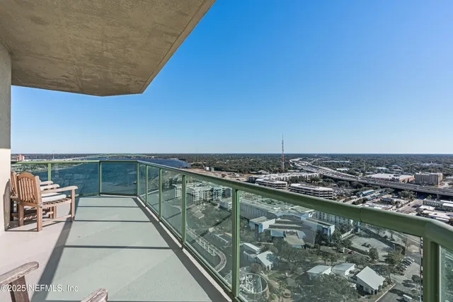 a view of roof deck with a table and chairs