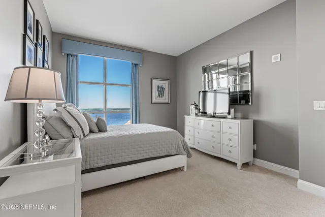 a bedroom with a large bed and a dresser