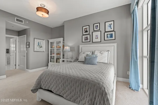 a bedroom with a large bed and a window