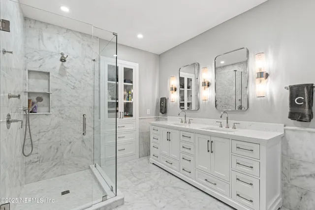 a bathroom with a shower sink and mirror