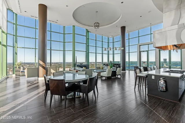 a view of dining room and livingroom with lots of furniture wooden floor and a rug