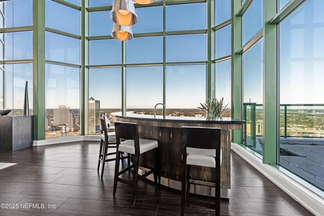 a view of a dining room with furniture window and wooden floor