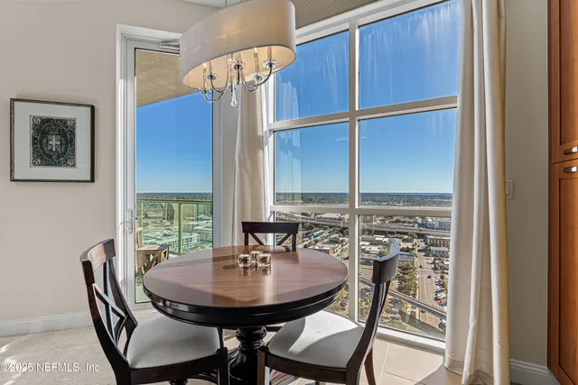 a view of a dining room with furniture and window