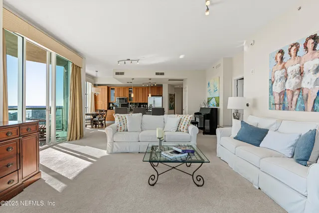 a living room with furniture and a large window