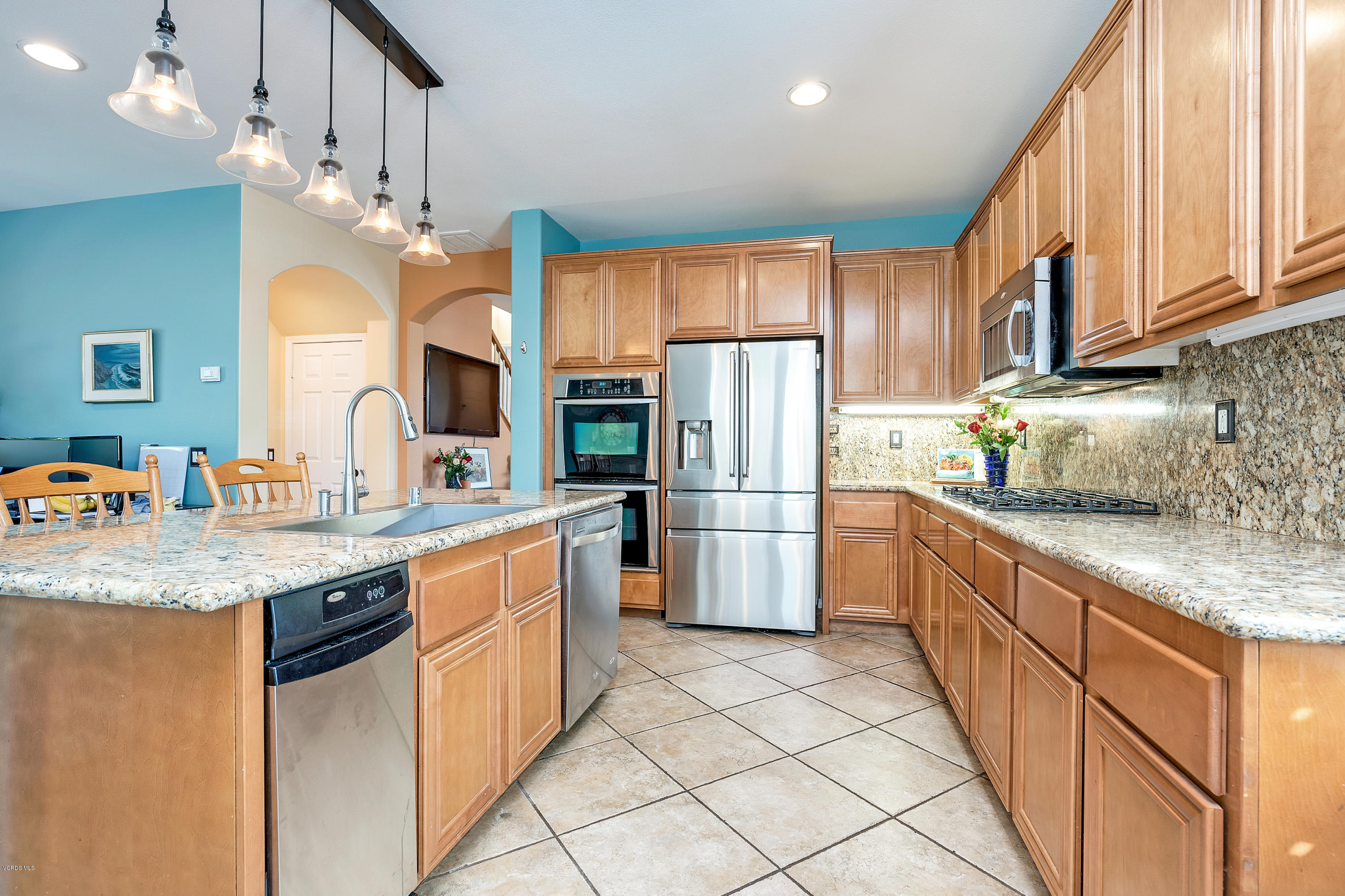 507 Spring Park Road Camarillo, CA 93012 - Photo 12 of 34 a kitchen with stainless steel appliances granite countertop a sink refrigerator and cabinets
