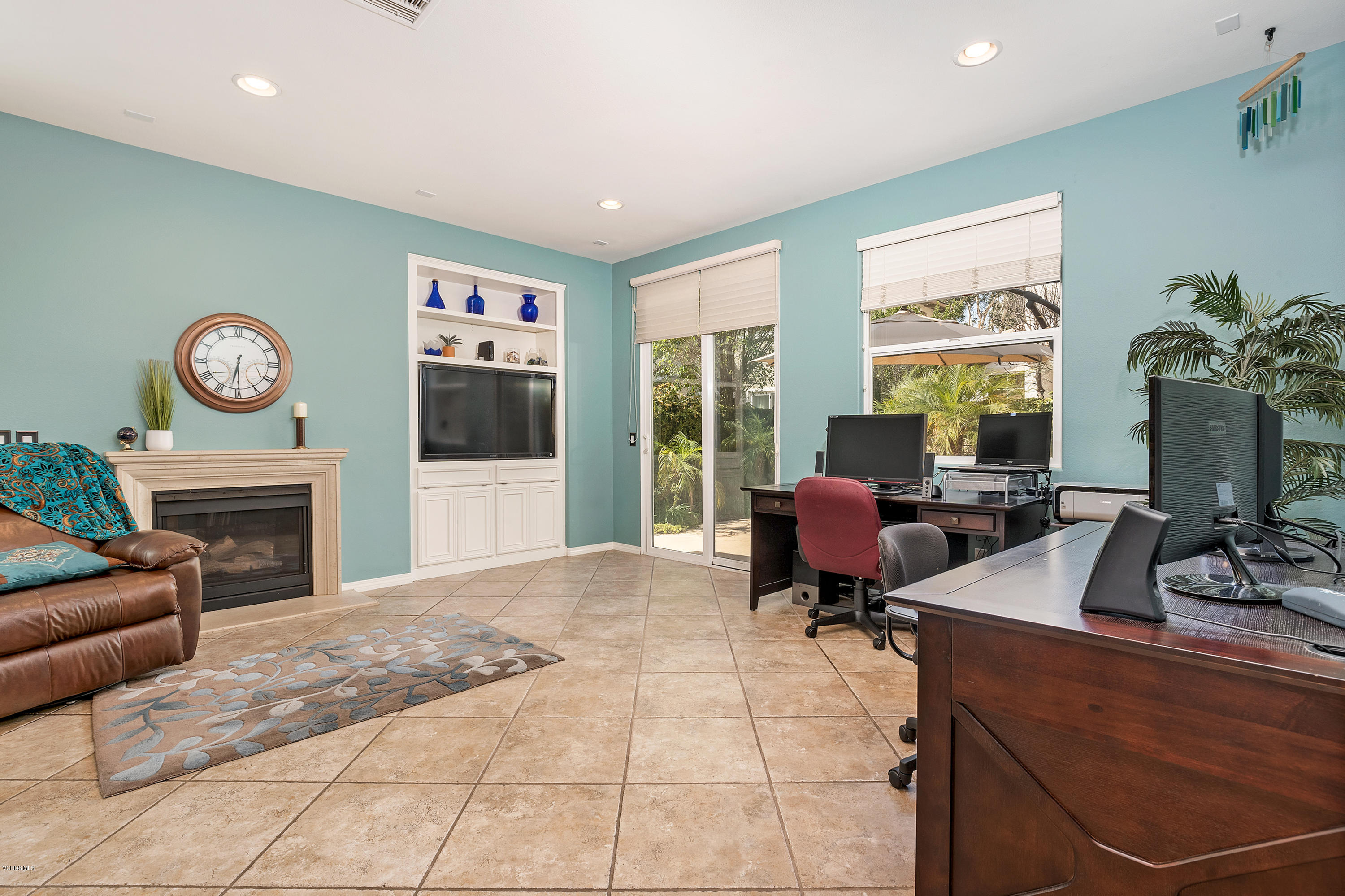 507 Spring Park Road Camarillo, CA 93012 - Photo 14 of 34 a living room with furniture a fireplace and a flat screen tv