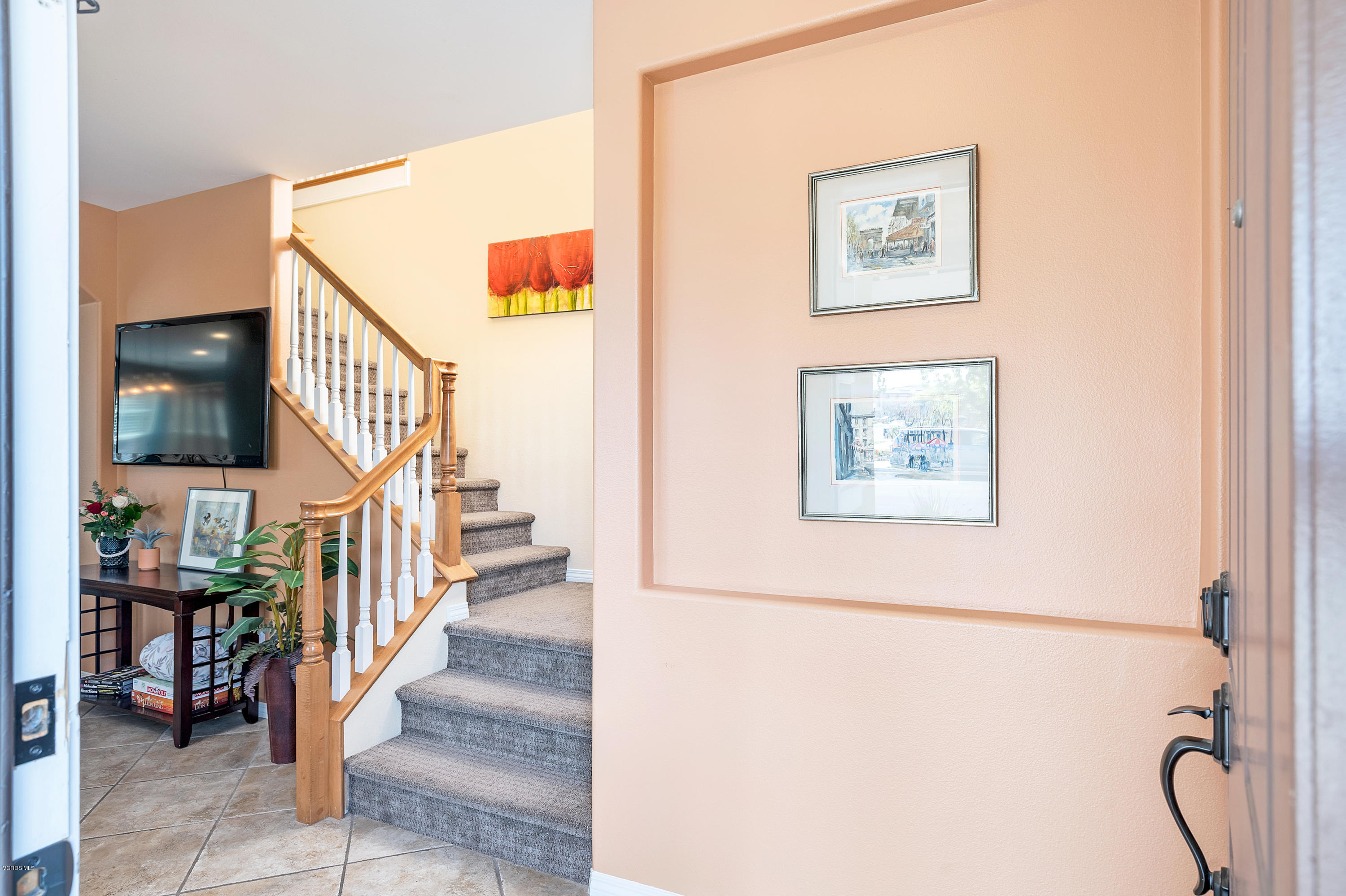 507 Spring Park Road Camarillo, CA 93012 - Photo 9 of 34 a view of a hallway with paintings on the wall