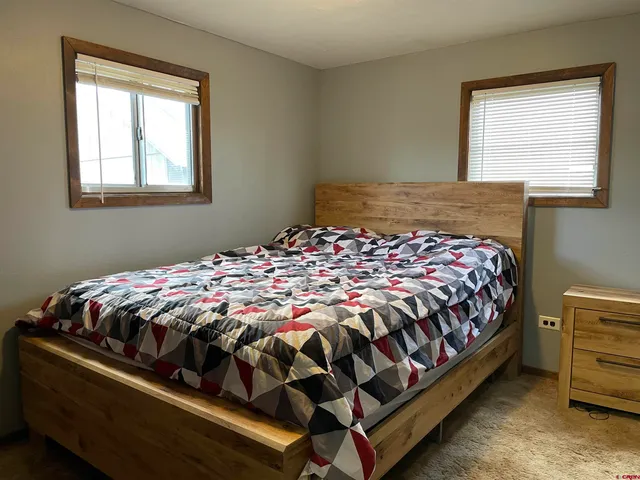 a bedroom with a bed and window