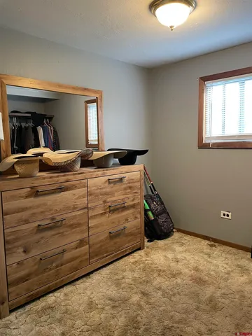 a bed room with a bed and a window