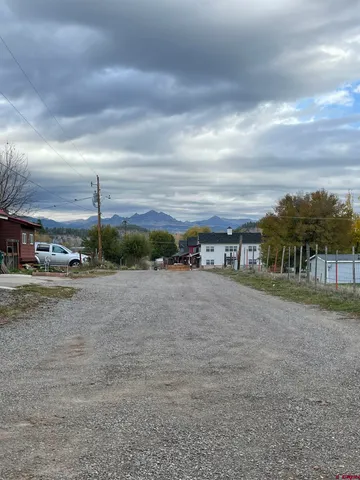 a view of a house with a yard and sitting area