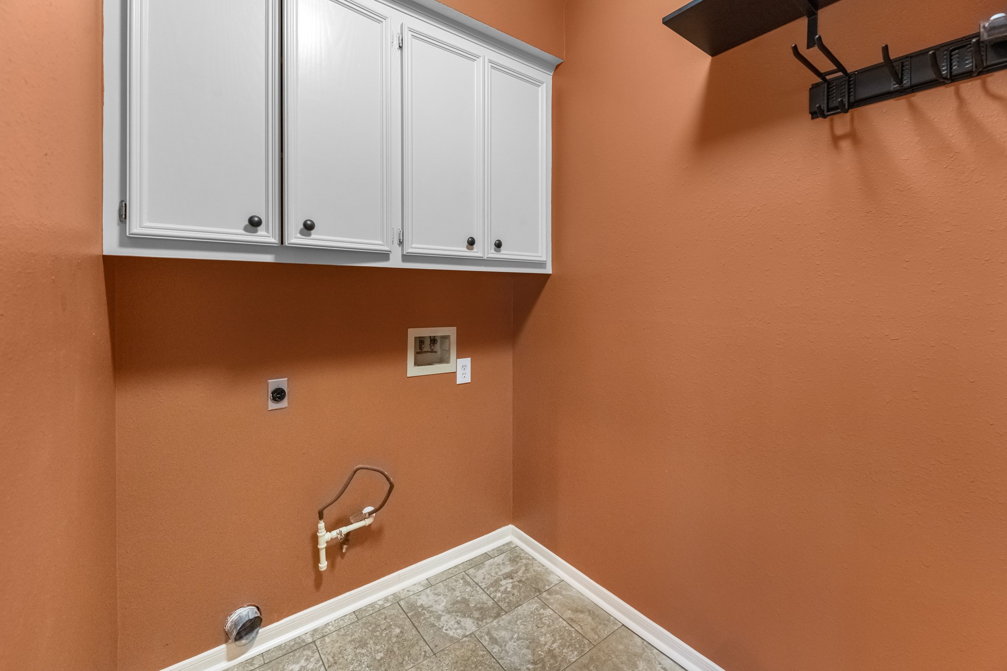 17126 County Road 39 Rosharon, TX 77583 - Photo 9 of 47 Large laundry room, wood cabinets and room to hang clothes and brooms etc.