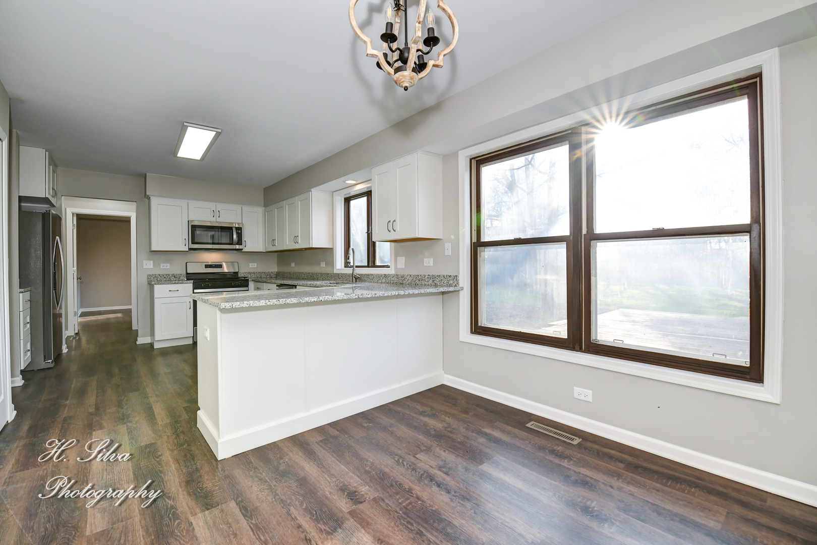 331 Cornell Lane Algonquin, IL 60102 - Photo 11 of 30 a kitchen with stainless steel appliances granite countertop a stove a sink and a refrigerator with wooden floors