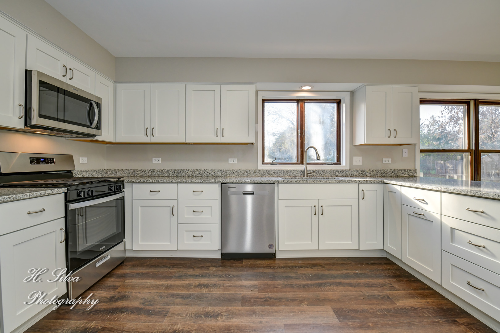331 Cornell Lane Algonquin, IL 60102 - Photo 7 of 30 a kitchen with granite countertop white cabinets stainless steel appliances a sink and a window