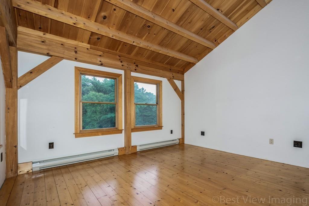 3 Ralph Road Hopkinton, MA 01748 - Photo 18 of 28 a view of an empty room with wooden floor and a window