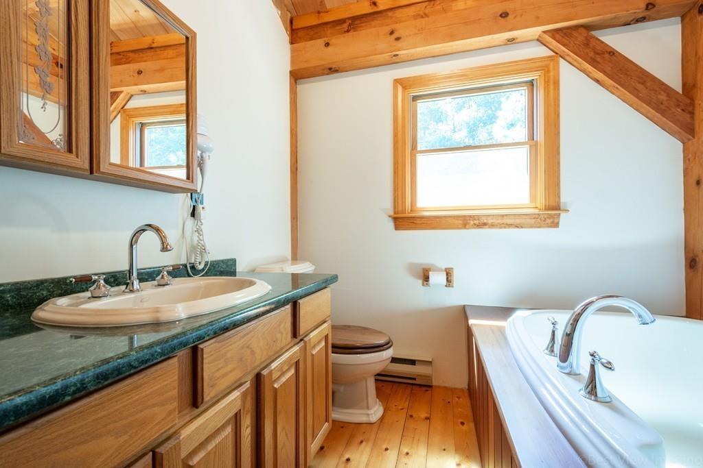 3 Ralph Road Hopkinton, MA 01748 - Photo 19 of 28 a bathroom with a granite countertop sink a toilet and a bathtub