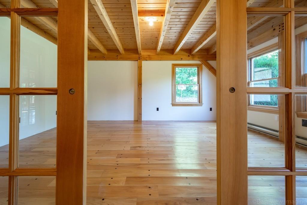 3 Ralph Road Hopkinton, MA 01748 - Photo 4 of 28 a view of empty room with wooden floor and windows