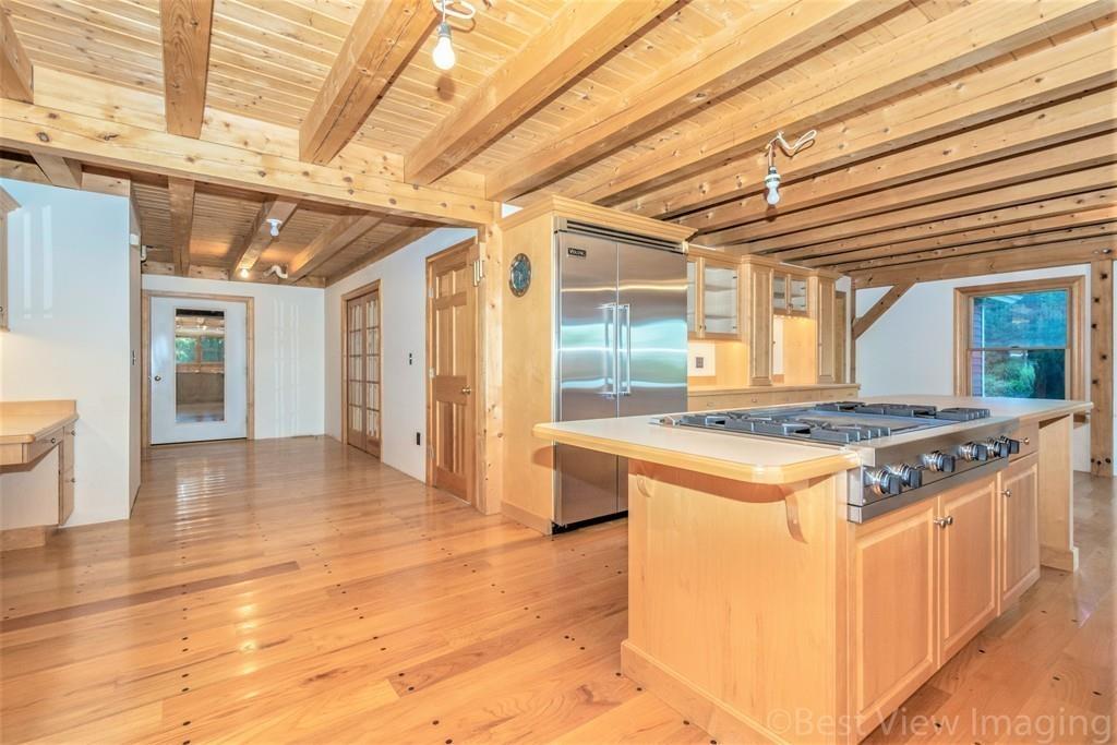 3 Ralph Road Hopkinton, MA 01748 - Photo 9 of 28 a kitchen with a stove and wooden cabinets