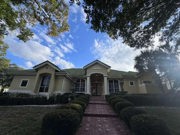 a front view of a house with a garden
