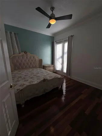 a bedroom with a bed and a chandelier