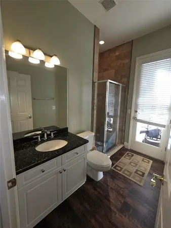 a spacious bathroom with a double vanity sink toilet mirror and bathtub