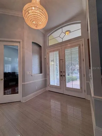 an empty room with a fireplace and windows