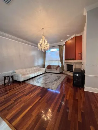 a view of a room with wooden floor