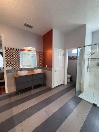 a bathroom with a double vanity sink and a mirror