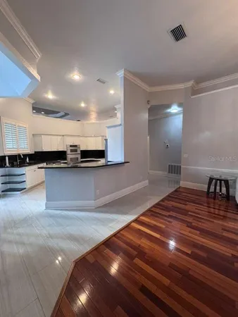 a view of kitchen with stainless steel appliances granite countertop a stove and a sink