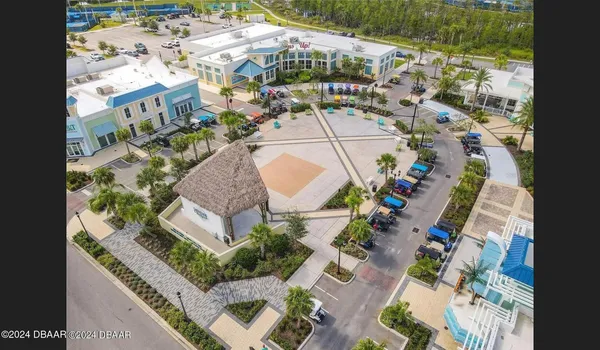 an aerial view of a house with a swimming pool and outdoor seating