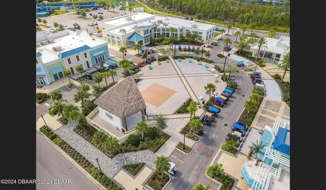 a view of a patio with a dining table and chairs with wooden floor