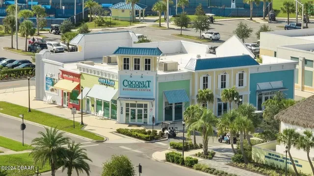 a dining room with lots of wooden furniture and a chandelier