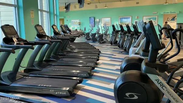 a view of gym equipment and floor to ceiling window