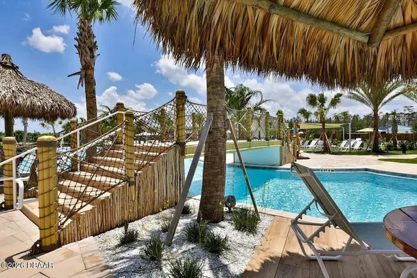 a view of a swimming pool with outdoor seating