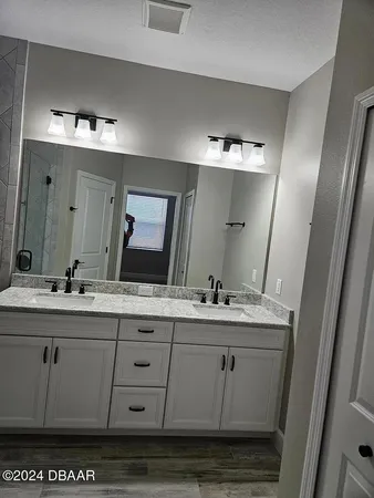 a bathroom with a sink vanity and mirror