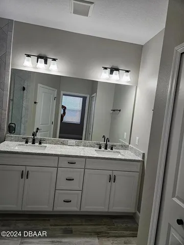 a bathroom with a granite countertop sink toilet and shower