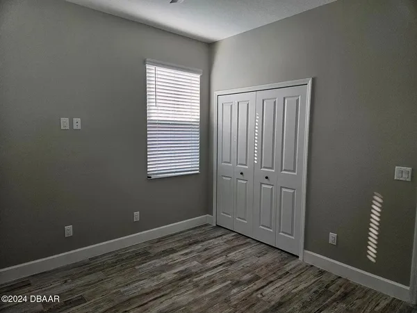 a view of wooden floor and windows in a room